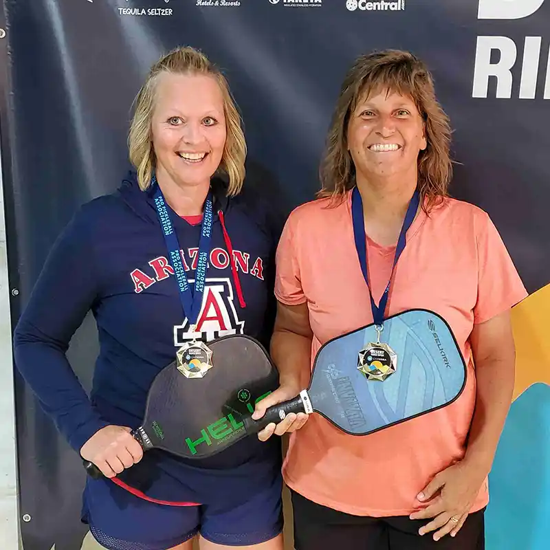 Kathy Coleman, Scottsdale Pickleball Coach, showing off her winning medal after a pickleball tournament
