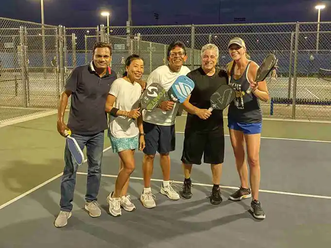 Nick Della, pickleball coach in Scottsdale Arizona posing with a group of his students